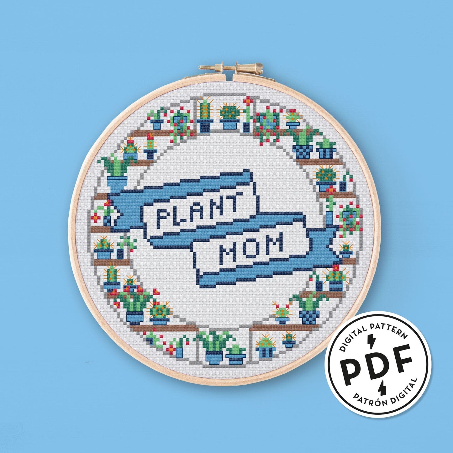 Esquema de punto de cruz en PDF Plant Mom. Bordado redondo, con cactus alrededor y una cinta de estilo tatuaje clásico con el mensaje