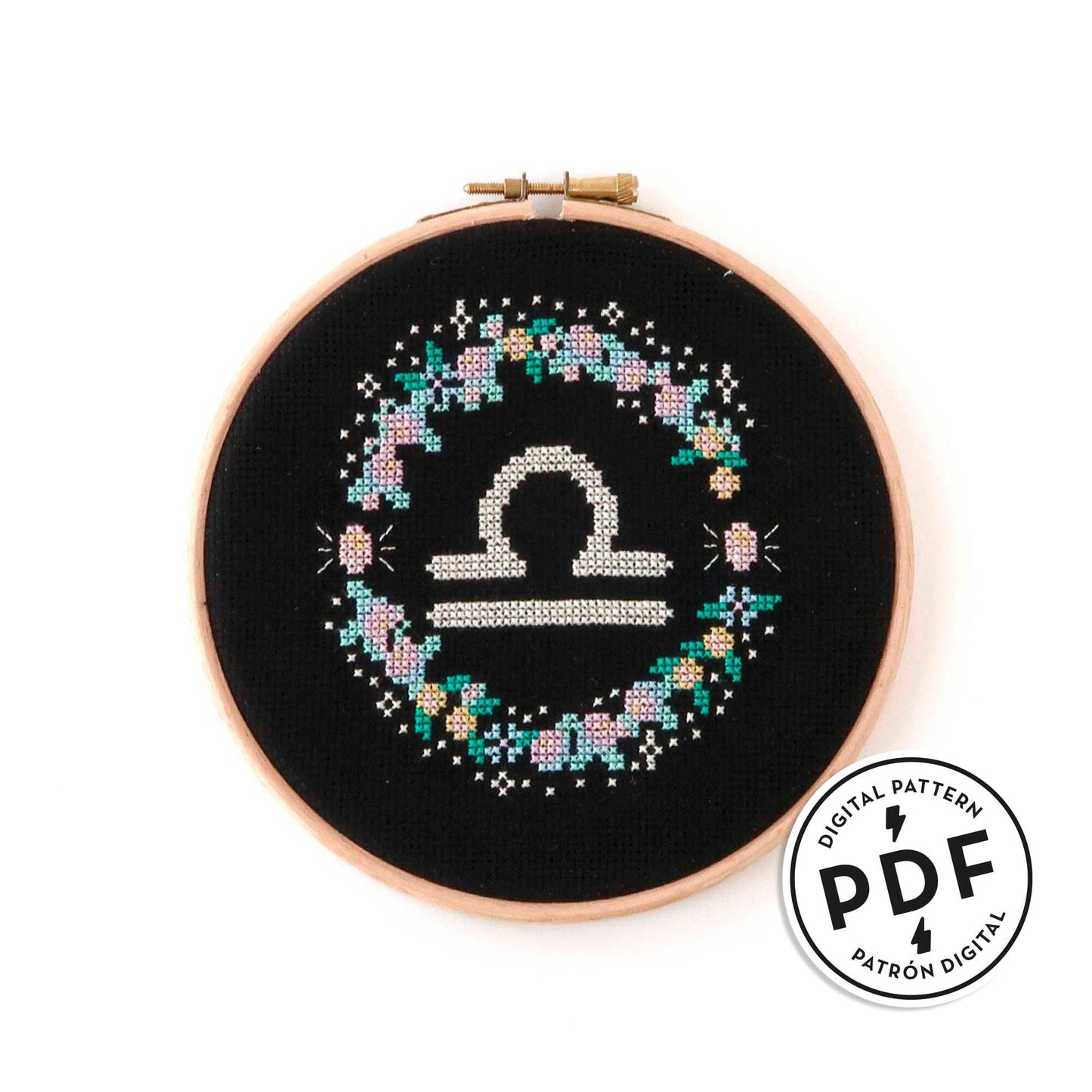 Patrón de punto de cruz en PDF con el signo de libra rodeado de flores en tonos pastel. Zodíaco de punto de cruz moderno y redondo para enmarcar en aro de bordar.